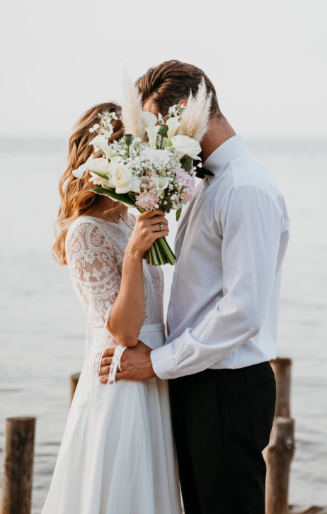beautiful-couple-having-their-wedding-beach-scaled-e1710508582910